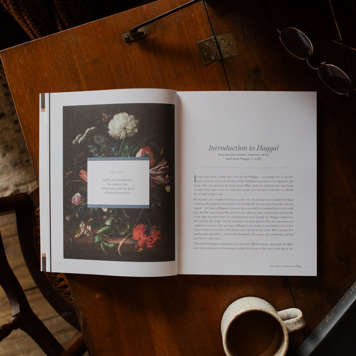 Haggai study opened to the introduction to Haggai page on a wooden desk near a pair of eyeglasses