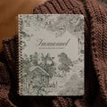 The Immanuel Spiral cover on a woven blanket on a leather couch