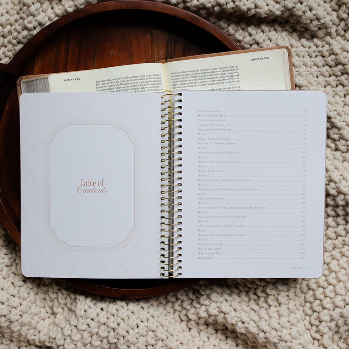 In Christ Alone Study opened to the Table of Contents page on an open Bible on a wooden tray on a knitted blanket