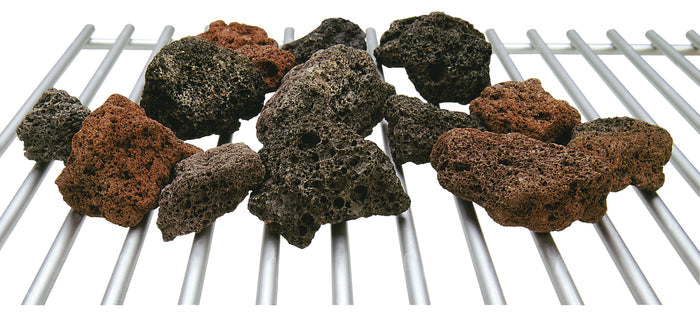 Assorted brown and black lava rocks on a metal grate.