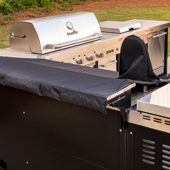 Silver Chef's Grill outdoor cooking station with black countertop covers.