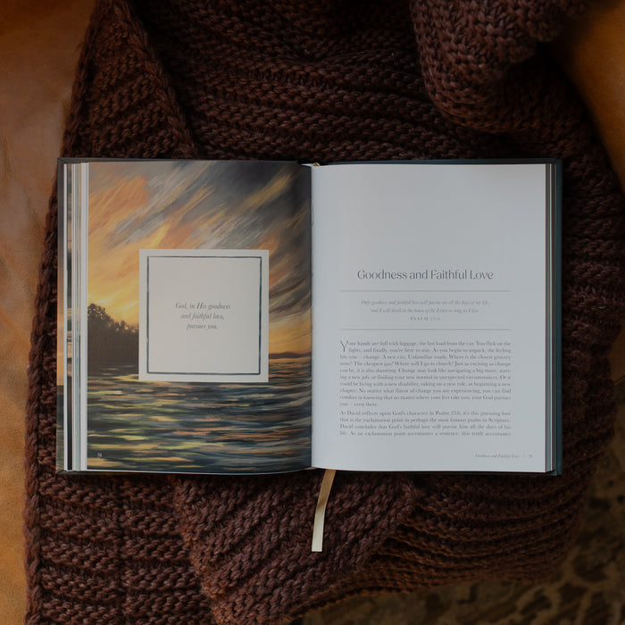 New and Never Ending Mercies opened to the Goodness and Faithful Love page on a brown knitted blanket on a leather couch