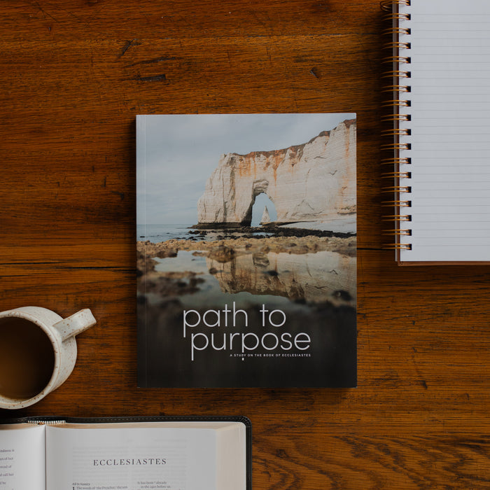 The Path to Purpose cover on a wooden table near a coffee cup