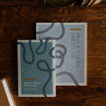 Peace Under Pressure Men and Womens Study cover on a wooden table  next to a journal