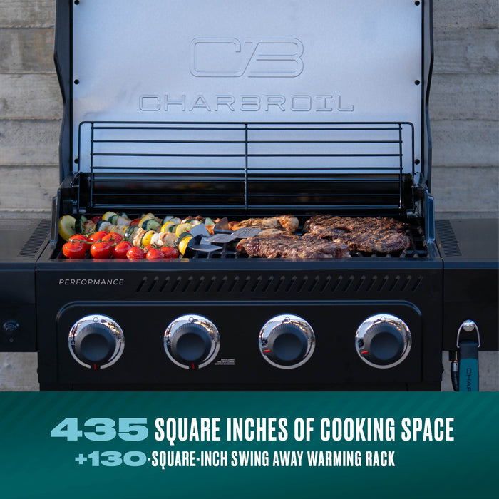 Char-Broil Performance grill with 435 square inches of cooking space, cooking steaks and vegetables.