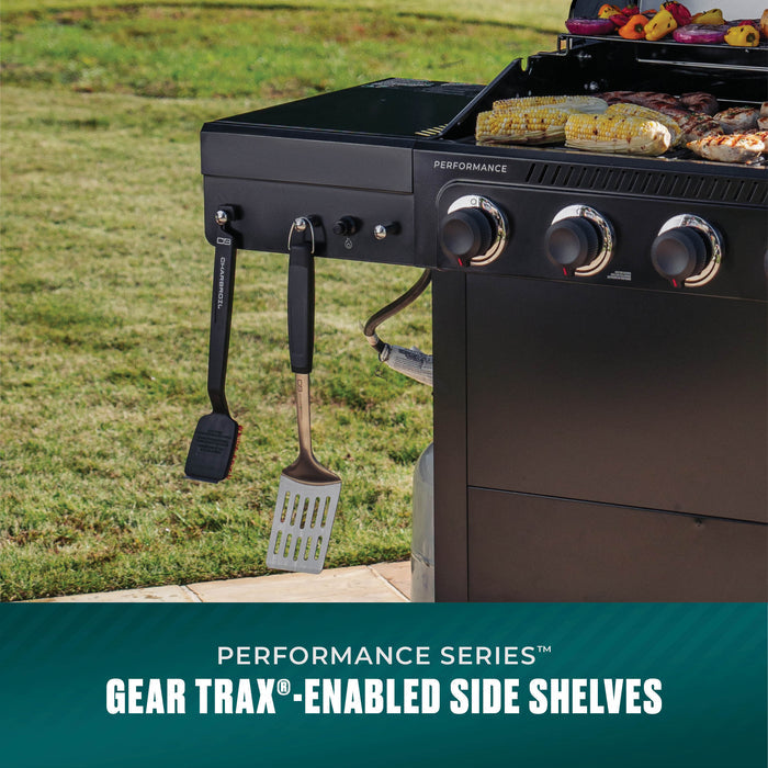 Black Char-Broil Performance Series gas grill with hanging spatulas and corn cooking.