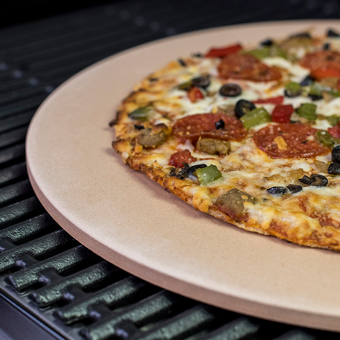 Pizza on beige plate with cheese, pepperoni, olives, and peppers.
