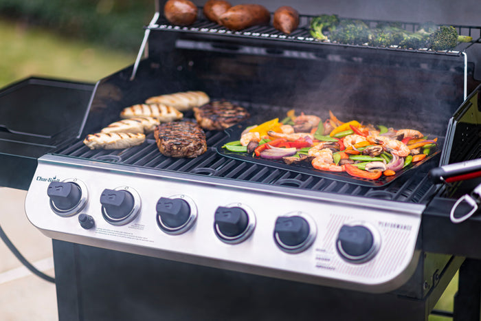 Black Char-Broil electric grill cooking chicken, steak, shrimp, and vegetables.