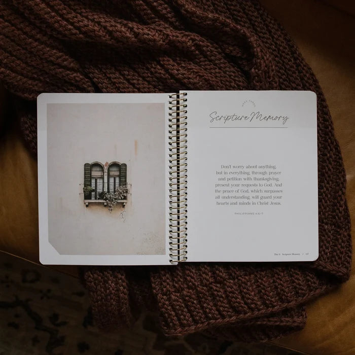 The Pray Spiral Study opened to the scripture memory page on a woven blanket