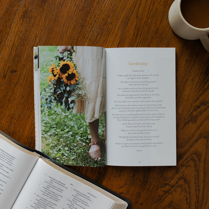 The Prayers for your Day opened to the gardening page on a wooden table near a coffee cup