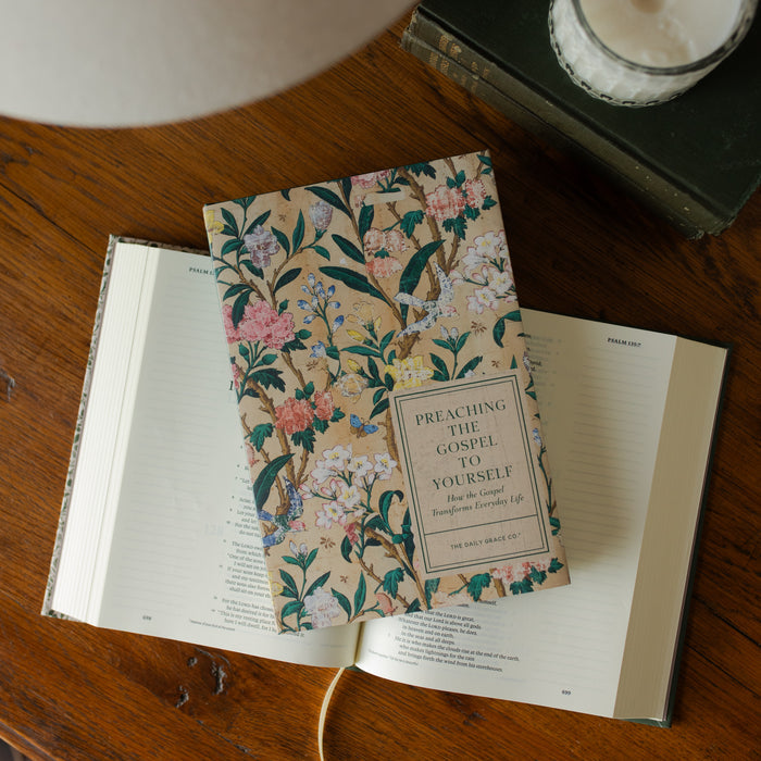 The Preaching the Gospel to yourself cover on an open bible on an open bible