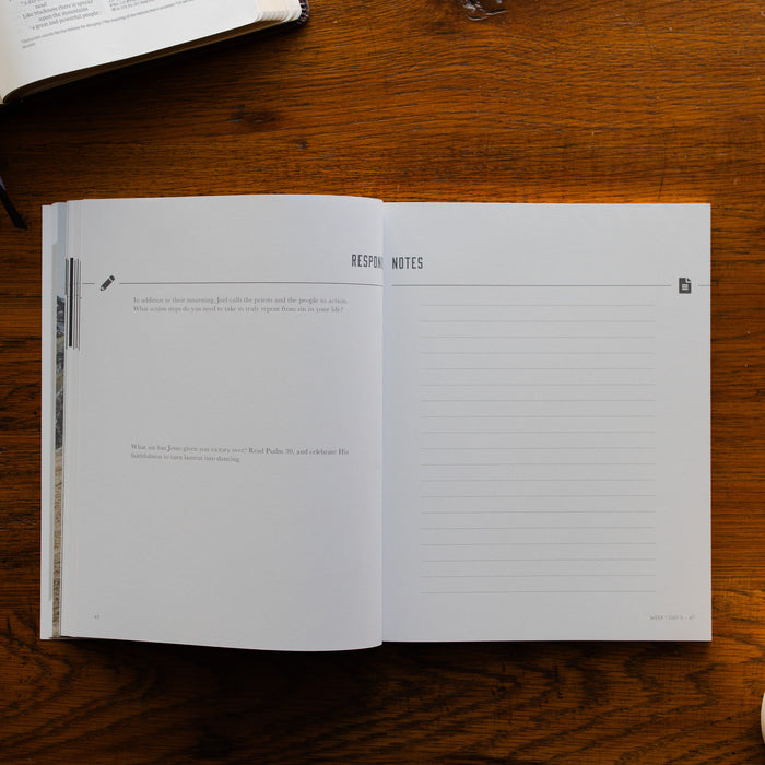 Restored Mens Study opened to the notes and responses page on a brown wooden table
