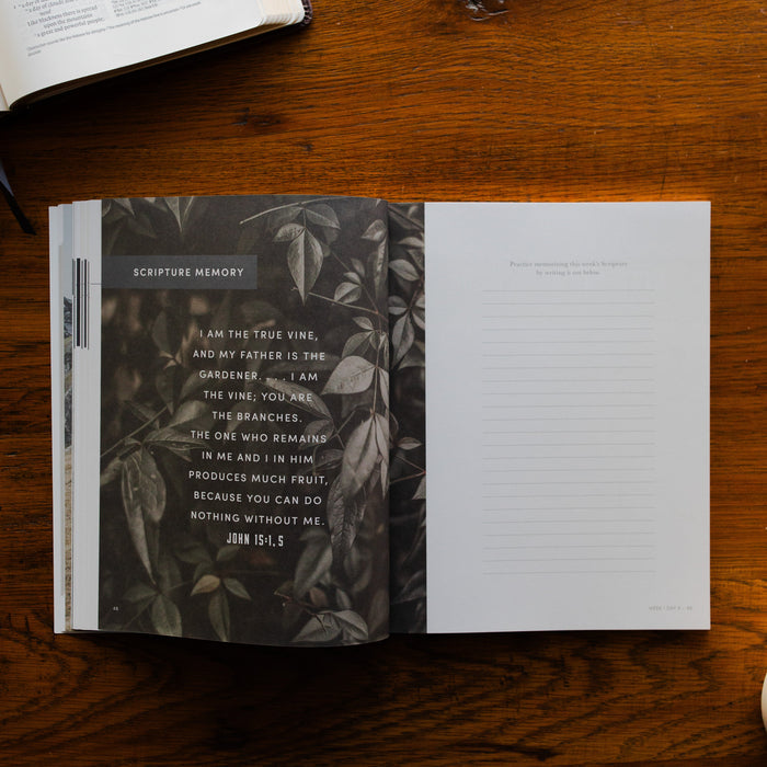 Restored Mens Study opened to the Scripture Memory page on a brown wooden table next to an open book