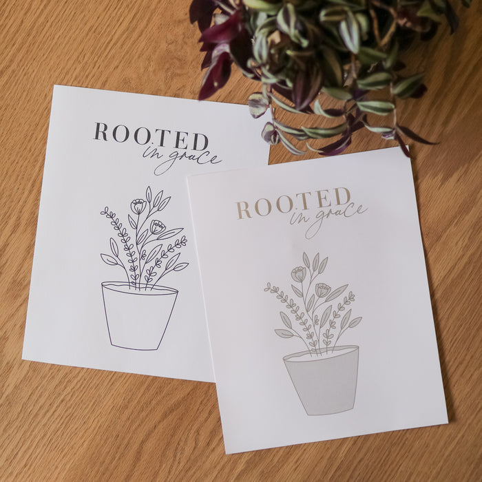 Rooted in grace printout of a plant on a wooden table.