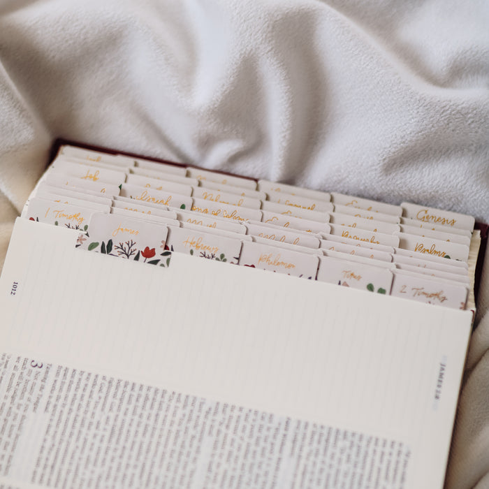 Open Bible with Rust Floral Bible tabs with gold script.