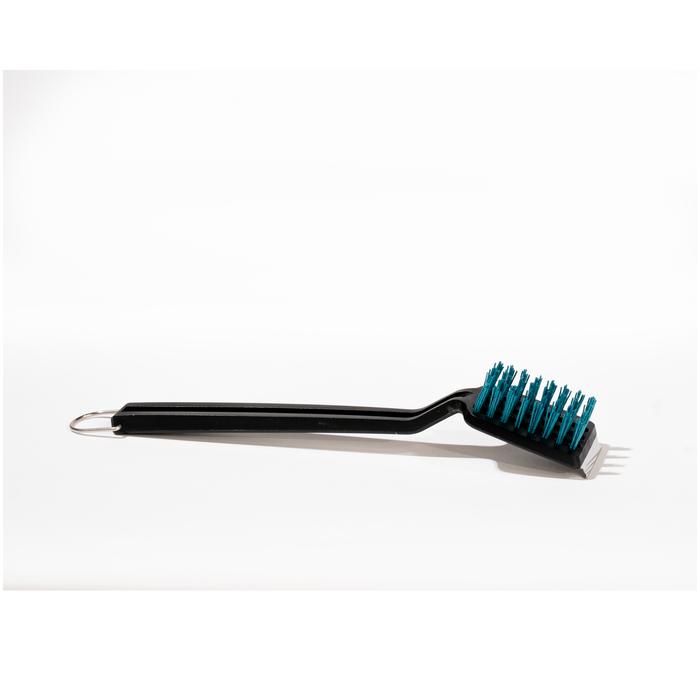 Black grill brush with teal bristles and metal handle.
