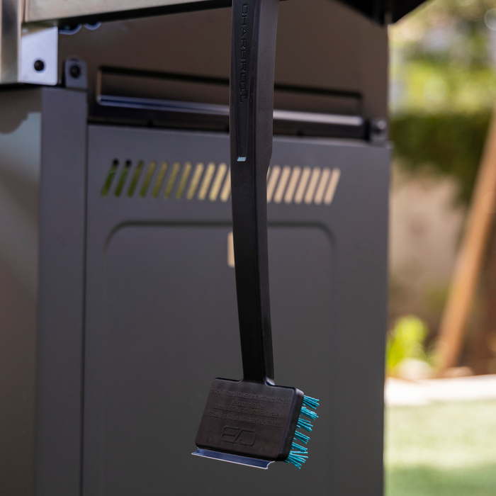 Black Char-Broil grill with teal accents and outdoor setting.