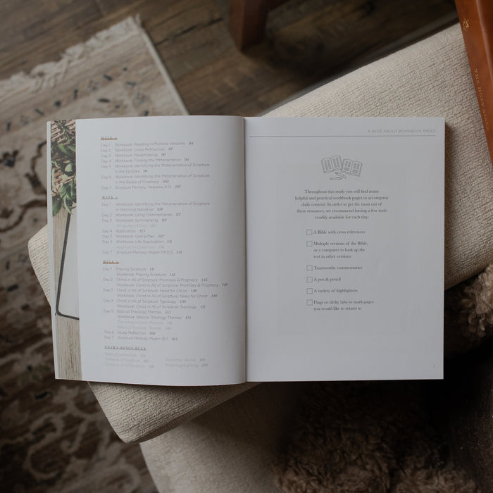 Open book on a textured surface with a blurred background