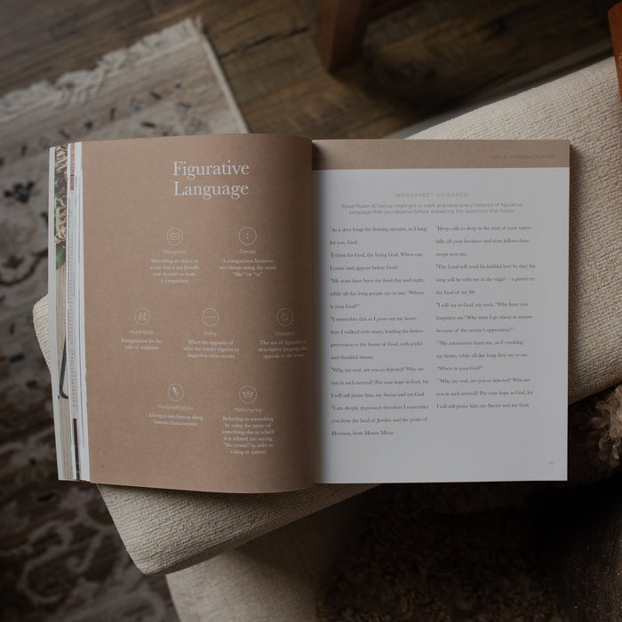 Open book on a wooden surface with text and illustrations.