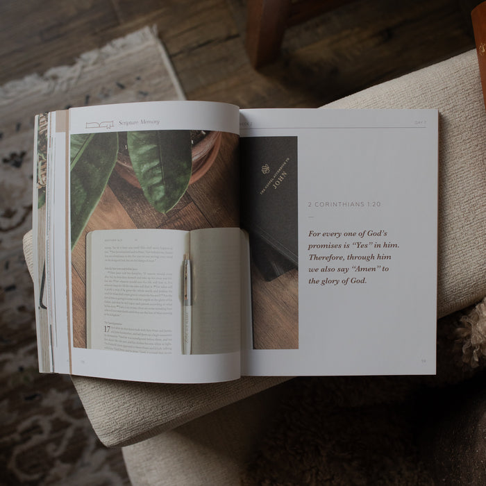 Open book with text and images on a wooden surface