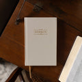 Beige notebook titled 'Sermon Notes' on a wooden surface