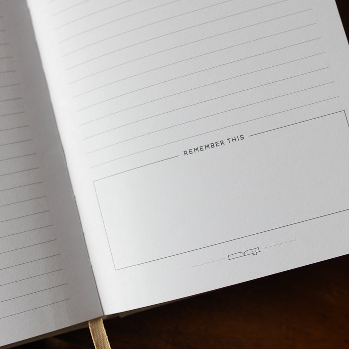Notebook with pre-printed columns on a wooden surface