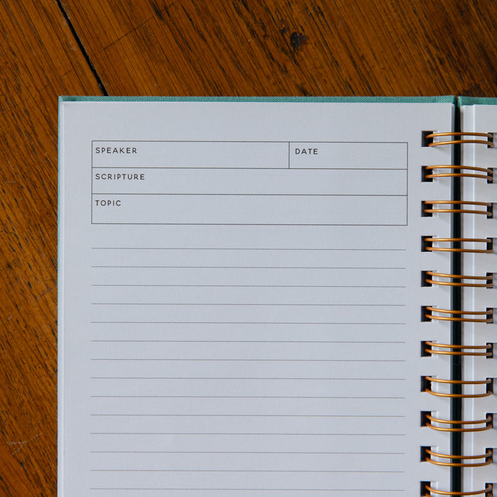 Notebook with pre-printed columns on a wooden surface