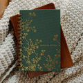 The Sermon Notes Journal with Green Floral on a bible and a knitted blanket