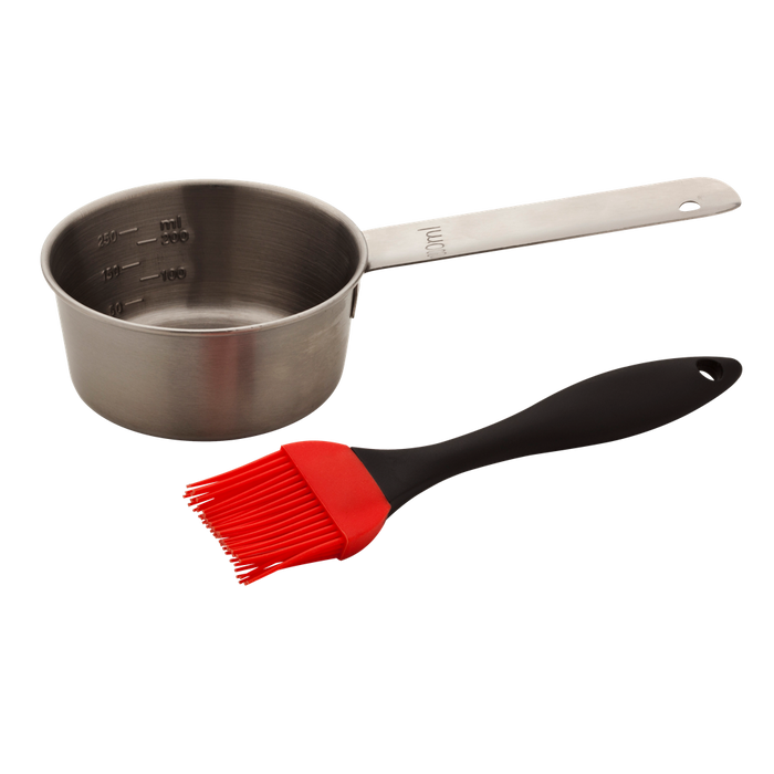 Stainless steel measuring cup with black silicone brush and red bristles.