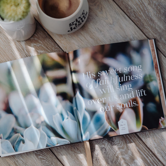 Devotional book opened to a page with writing and pictures