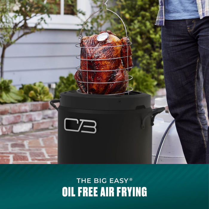 Outdoor oil-free air fryer with a wire basket holding a roasted turkey; black cylindrical design, easy-to-use handles.