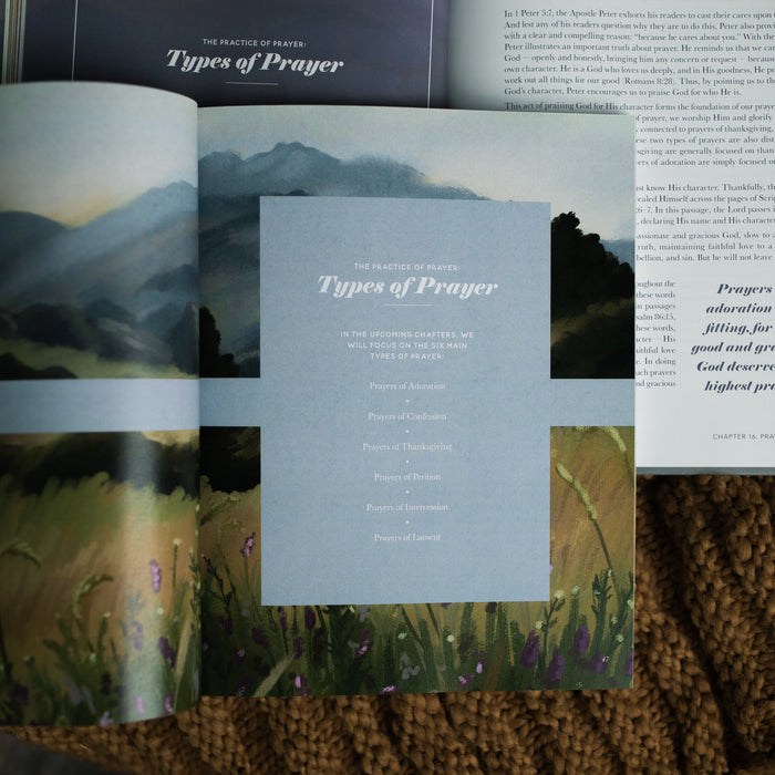 The Companion Guide to The Prayer Handbook opened to the Practice of Prayer laying on a Prayer Handbook opened to the Practice of Prayer on a brown knitted blanket