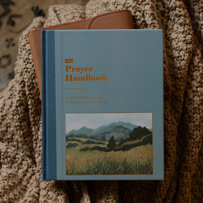 Book on prayer sitting on blanked