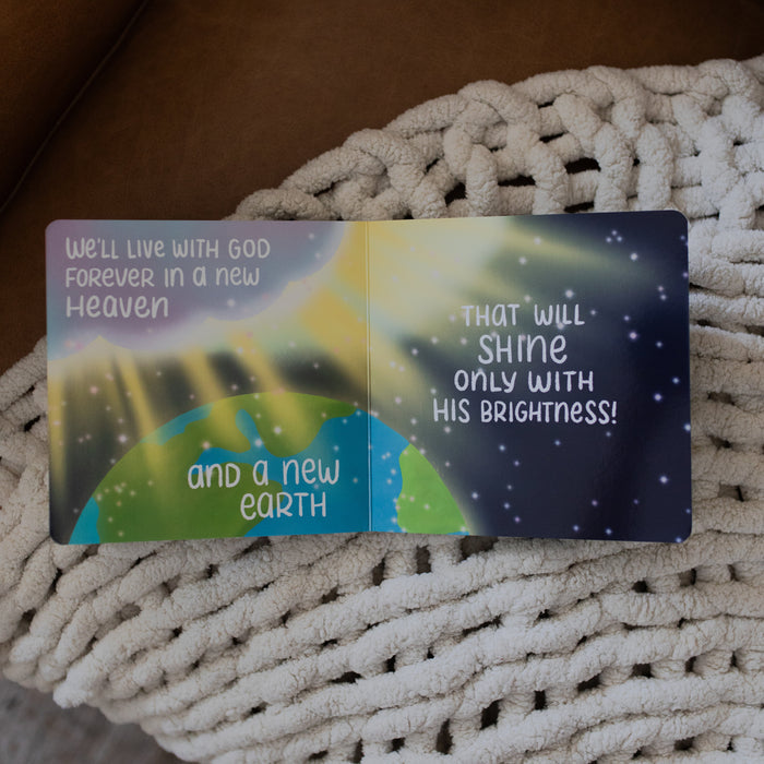 Jesus Makes Everything New Board Book opened to an a new heaven and earth page laying on a white knitted blanket