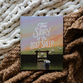 The Story of the Lost Sheep Book Cover laying on multiple blankets