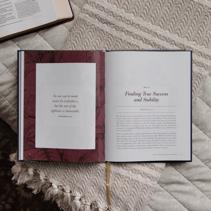 Open devotional on a textured surface with text visible
