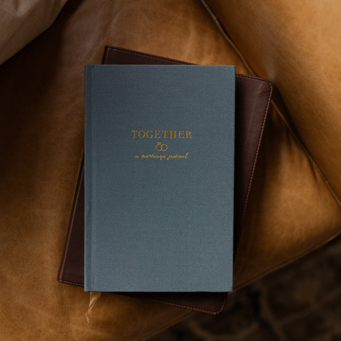 Blue book titled 'Together' on a brown leather surface