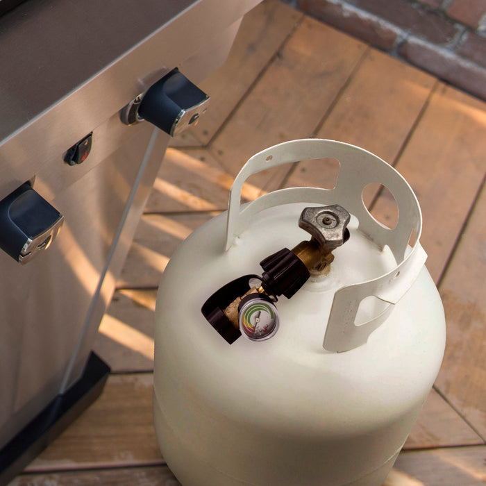 White propane tank with pressure gauge and valve, secured with black straps.