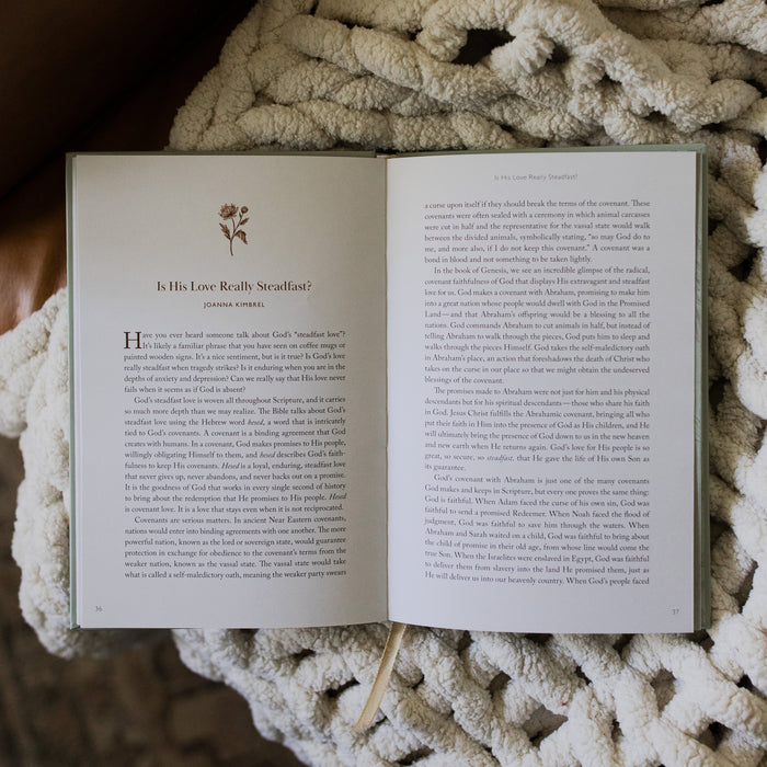 What a friend we have in Jesus opened to the Is His love really steadfast page on a white knitted blanket on a leather couch