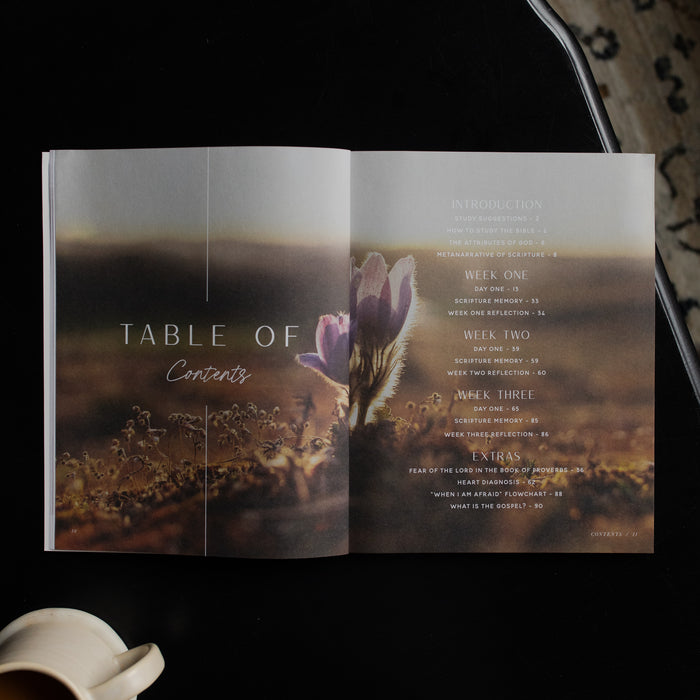 Open book with a table of contents featuring a floral design on a dark background